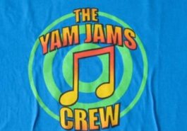 Image shows a colourful music note and the words the Yam Jams crew printed on a blue t shirt background