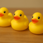 Three Yellow Rubber ducks in a row